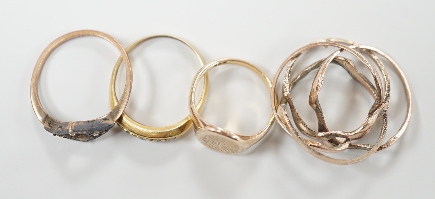 An 18ct gold and five stone diamond chip set ring, size L, gross 2.7 grams, two 9ct rings including small signet, gross 3.4 grams and a yellow metal puzzle ring.